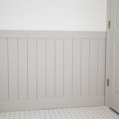 a bathroom with white walls and tile flooring