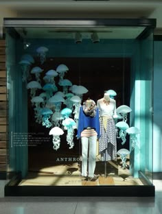 a display case with mannequins dressed in blue and white