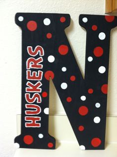 the letter n is decorated with red, white and black polka - dot dots on it