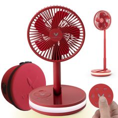 a red table fan sitting on top of a stand