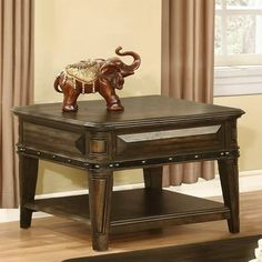 an elephant figurine sitting on top of a coffee table in a living room