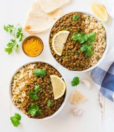 two bowls filled with lentils, rice and cilantro