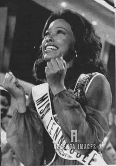 an old black and white photo of a woman wearing a miss america sash smiling at the camera