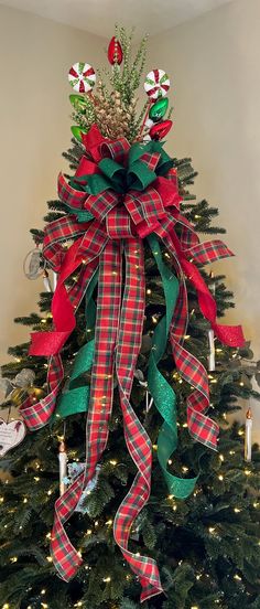 Bonnie is all things merry. Let her liven your tree this Christmas! She is made using three ribbons- the first is a sparkly green, the second is a lovely holiday plaid, the third is a sparkly red. The topper contains a variety of sprays featuring vintage looking lights.  For a 360 degree look, purchase the two bow option. Width-12" Loops-20 Streamers-13 long Length-4 ft Fabrics- 3 Bow Displayed on a 6 1/2' slim tree, bow may appear differently depending on the size and shape of your tree. Each bow is packed with a lot of tissue paper between loops to ensure it arrives in pristine condition. Simply take the bow out of the bow, remove the tissue paper and attach to wherever you want it! Each bow is unique with slight variations Suitable for indoor or covered outdoor use Weather Resistant / N Red Green Plaid Christmas Tree, Bow Christmas Tree Topper, Christmas Tree Toppers Unique, Bow Display, Slim Tree, Christmas Tree Topper Bow, Toppers Diy, 4th July Crafts, Tree Topper Bow