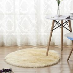 a table and chair in a room with a rug on the floor next to it