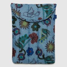 a blue purse with flowers and leaves on it