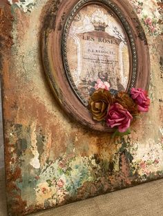 an old frame with flowers on it