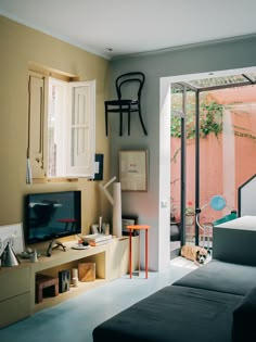 a living room filled with furniture and a sliding glass door