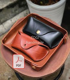 two leather cases sitting on top of each other