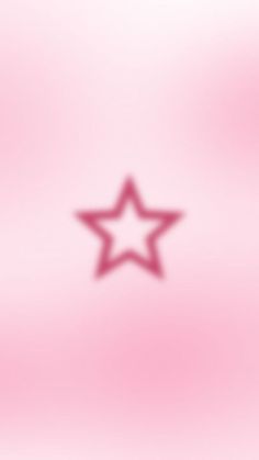 a blurry image of a star on a pink background