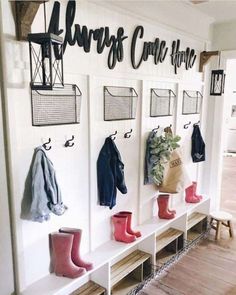 the entryway is decorated with boots, coats and coat racks for hanging on the wall