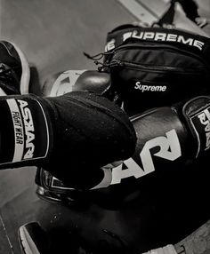 black and white photograph of two pairs of boxing gloves on top of each other,