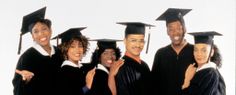 a group of people in graduation gowns posing for a photo