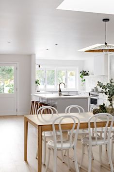 a kitchen and dining room with white walls