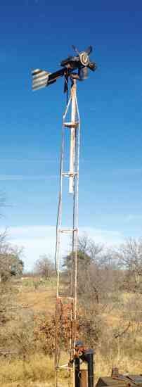 an old fashioned windmill in the middle of nowhere