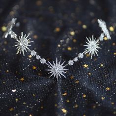 a close up of a necklace with snowflakes on it