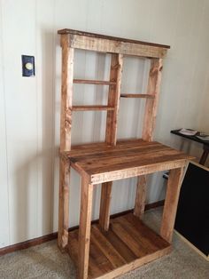 a wooden shelf sitting in the corner of a room