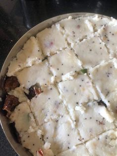 a pan filled with food sitting on top of a stove