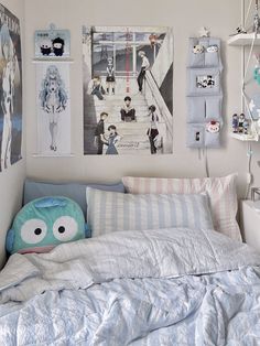 a bed room with a neatly made bed and pictures hanging on the wall above it