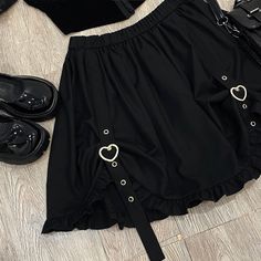 Buckle up with this Heart Buckle Skirt! Size Chart: Size Waist (cm) Length (cm) Waist (in) Length (in) One Size 62-86 45 24.41-33.86 17.72 Description: Silhouette: AsymmetricalMaterial: Cotton/SpandexDecoration: ButtonOrigin: CN(Origin)Waistline: EmpirePattern Type: SolidDresses Length: Above Knee, MiniFabric Type: BroadclothSkirt length: Short Skirt Gothic Skort For Spring, Cute Black Party Skirt, Cute Fitted Black Skirt, Cute Black Summer Skirt, Cute Black Bottoms For Party, Cute Black Mini Skirt For Party, Cute Black Mini Skirt For Spring, Gothic Mini Skirt For Spring, Spring Gothic Mini Skirt