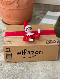 an elf sitting on top of a cardboard box