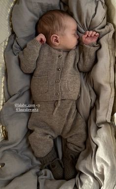 a baby is laying down in a basket