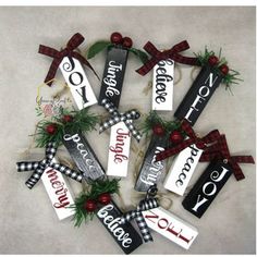 christmas ornaments are arranged in the shape of a wreath with red and black ribbons on them