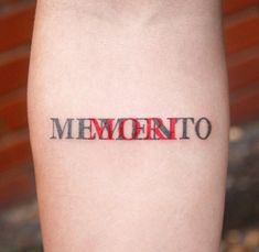 the word mementoito written in red ink on someone's left calf leg