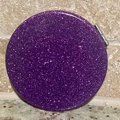 a purple button sitting on top of a counter