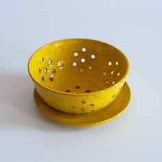 two yellow bowls sitting on top of each other