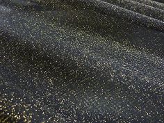 black and gold glitter fabric with white dots