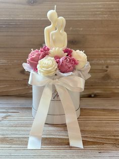 a small white box with pink and white flowers in it