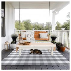 a dog is laying on a porch swing