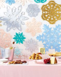 the cover of good things magazine, featuring paper snowflakes and desserts on a table