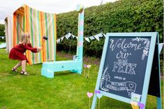 a chalkboard sign in the middle of a lawn