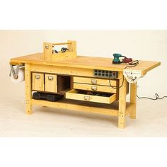 a workbench with drawers and tools on it