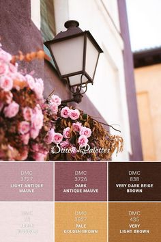 a lamp post with pink flowers on it next to a building and the words dncc light antique mauve