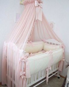 a baby crib with a pink canopy over it