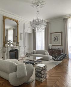 a living room filled with furniture and a chandelier