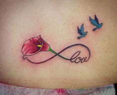 a woman's stomach with a tattoo on it that says love and two birds flying around