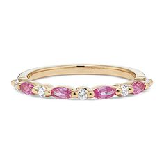 a yellow gold ring with pink and white stones