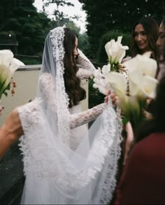 the bride is getting ready to walk down the aisle in her wedding dress and veil