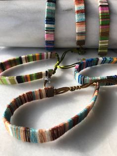 multicolored bracelets are laying on top of each other