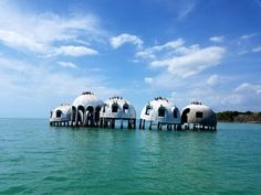 the domes are in the middle of the water and they look like they're floating on land