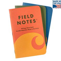 three notebooks with the words field notes written on one side and an orange, blue, and green cover