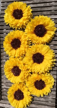 sunflowers are arranged on the side of a bench