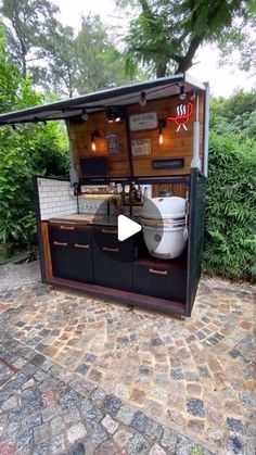 an outdoor kitchen with two large pots on it