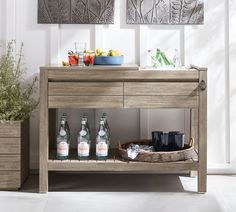 a wooden table with bottles and glasses on it