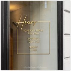 the front window of a restaurant with gold lettering on it's glass and a sign that says hour