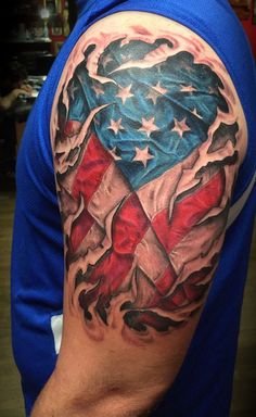 a man with a tattoo on his arm that has an american flag in the shape of a heart